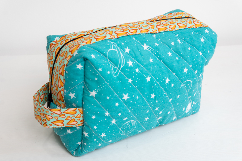 A quilted make up bag made in space print polycotton